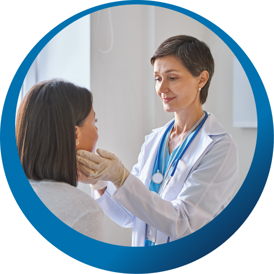An oncologist examining a patient during a follow-up visit.